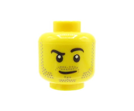 Głowa figurki LEGO w kolorze żółtym, męska, zarost, uniesiona brew